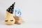 pumpkin in party hat and goft boxes on gray background , new year or christmas minimal concept party time