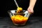 Pumpkin pieces and blender in a glass bowl on black table. Chopped butternut squash, cooking vegetable food, pumpkin puree mash