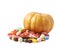 Pumpkin and pile of candies isolated