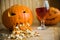 Pumpkin puking with pumpkin seeds on wood table, glass of wine