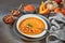 Pumpkin and red lentil creme soup in ceramic bowl seasoned with basil, cream and croutons