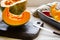 Pumpkin, rustic arrangement with pumpkin cut into pieces, knife, board, wooden spoon, iron pot on a table