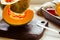 Pumpkin, rustic arrangement with pumpkin cut into pieces, knife, board, wooden spoon, iron pot on a table