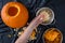 Pumpkin seed harvesting, womanâ€™s hands sorting seeds and pumpkin guts