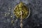 Pumpkin seeds in a glass bowl and silver spoon