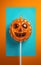 Pumpkin shaped lollipop background. Thanksgiving, Halloween minimalistic concept.