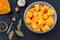 Pumpkin slices in a bowl prepared for baking