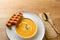 Pumpkin soup with belgian waffles on wooden background