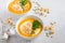 Pumpkin soup with cream, croutons, pumpkin seeds and parsley on a gray concrete or stone background.