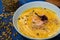 pumpkin soup with cream and shrimp, decorated with pumpkin seeds