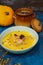 pumpkin soup with cream and shrimp, decorated with pumpkin seeds