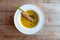 Pumpkin soup with seed and cinnamon stick in white round bowl.