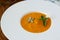 Pumpkin soup in white modern plate, dietary vegetable