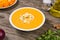 Pumpkin soup in a white plate. Selected focus