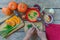 Pumpkin soup on wooden table, vintage. Woman hands, herbs, cooking process.