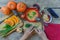 Pumpkin soup on wooden table, vintage. Woman hands, herbs, cooking process.