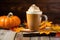 pumpkin spice latte with whipped cream on a wood slab