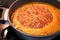 Pumpkin tomato peas soup boiling in the pot on the stove