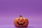 Pumpkin on a violet background, Halloween backdrop