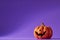 Pumpkin on a violet background, Halloween backdrop