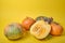 pumpkin on yellow background, pumpkin cut in half and some unusual pumpkins on yellow autumn leaves