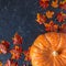 Pumpkins, acorns, yellow leaves on a dark background