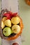 Pumpkins and Apples in Baskets on Wood Bench