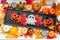 Pumpkins and autumn leaves on a white table. halloween dolls in a frame