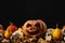 Pumpkins, autumnal leaves and decorative skulls
