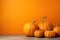 pumpkins on bright orange background with copy space, Happy Halloween concept, autumn holiday and harvest theme