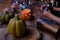 pumpkins, candles, little female witch prepares witch\'s potion, magic items on table, funny chemical experiments