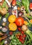 Pumpkins and delicious harvest vegetables ingredients for tasty cooking, preparation on dark rustic background