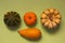 Pumpkins of different types over green