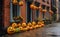 Pumpkins faces is stacked on wet urban pavement