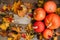 Pumpkins with fall leaves over wooden background