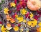 Pumpkins with fall leaves over wooden background. Top view. Halloween