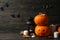 Pumpkins and halloween accessories on wooden background