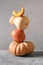 Pumpkins for Halloween or Thanksgiving Day of different shapes in balance composition on gray background.