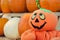 Pumpkins at harvest, celebrating Halloween on the farm with a friendly jack-o-lantern