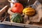 Pumpkins lying on a straw sack in a wooden box