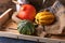 Pumpkins lying on a straw sack in a wooden box