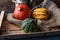 Pumpkins lying on a straw sack in a wooden box