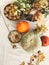 Pumpkins, nuts,yellow flowers, dried herbs, fall leaves on rustic table, top view. Fall decor and arrangement on table. Autumn