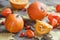 Pumpkins on old wooden table with maple leaves.