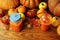 Pumpkins, persimmons, apples and leaves on a wooden background.