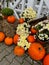 Pumpkins rustic hay decoration outdoors. Stylish autumn decor of exterior building. Rural decor on haystack in street