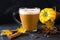 Pumpkins spice latte with pumpkins Pumpkin latte - cozy drink for cold fall or winter. On dark
