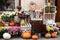 Pumpkins,squash and flowers on rustic wooden boxes in city street, holiday decorations store fronts and buildings. Halloween