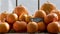 Pumpkins stacked up on shelf in farm shop, with slate board sign reading: Halloween pumpkins