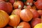 Pumpkins of the variety red kuri squash for sale at a farmers market, autumn vegetable for halloween and thanksgiving